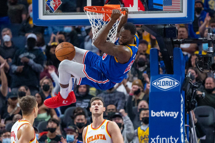November 8, 2021; San Francisco, California, USA; Golden State Warriors forward Draymond Green (23) dunks the basketball against Atlanta Hawks guard Bogdan Bogdanovic (13) and forward Danilo Gallinari (8) during the second quarter at Chase Center.
